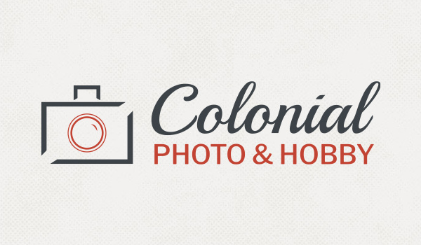 colonial photo and hobby logo on background of old cameras